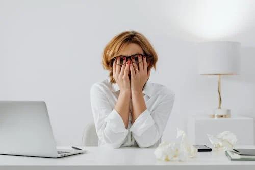 Woman looking stressed and overwhelmed, reflecting financial anxiety and emotional pressure